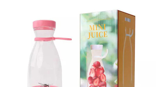 Pink and clear juice extractor with packaging on a white background